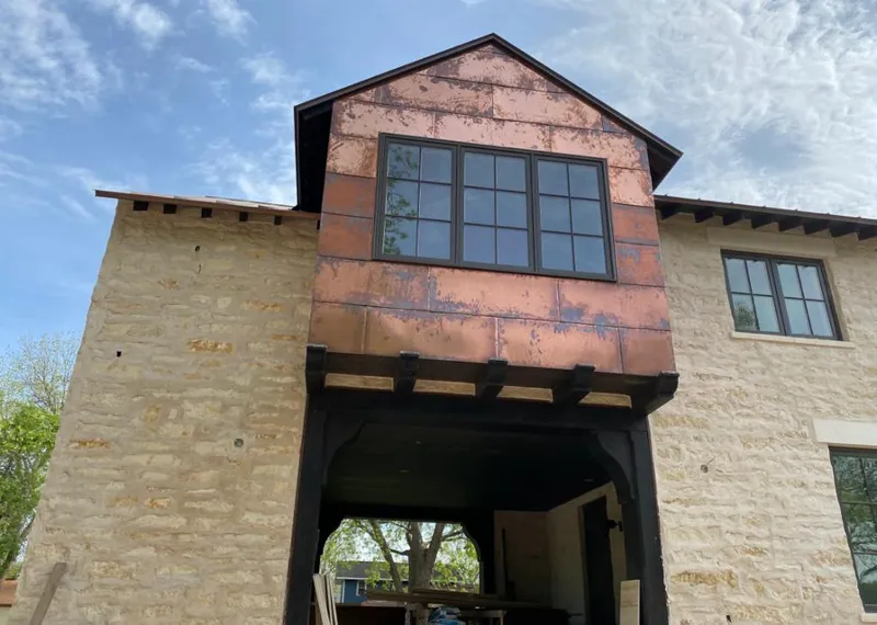 Copper metal panel facade on a stone building for Metal Roof Coating in West View