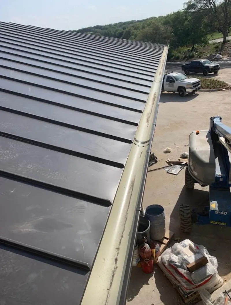 Standing seam panel and gutter detail on a metal roofing jobsite in West View